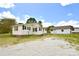 Charming home with vinyl siding, a gravel driveway, and two exterior storage buildings at 2306 W C St, Kannapolis, NC 28081
