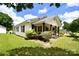 Quaint single-story home with a cozy front porch and flourishing garden beds at 2306 W C St, Kannapolis, NC 28081