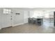 Open-concept kitchen and entryway with gray island, barstool seating, and ample counter space at 2306 W C St, Kannapolis, NC 28081
