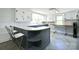 Bright eat-in kitchen with white cabinets, updated appliances, gray island and modern countertops at 2306 W C St, Kannapolis, NC 28081
