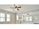 Bright living room with white painted brick fireplace, large windows, and ceiling fans at 2306 W C St, Kannapolis, NC 28081
