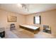 Unfinished room with a platform bed, exposed floors, and textured walls at 2306 W C St, Kannapolis, NC 28081