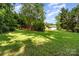 Expansive backyard with lush greenery, mature trees, and ample space for recreation at 2718 Ridgewood Ln, Rock Hill, SC 29730