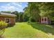 Expansive backyard featuring a storage shed, lush greenery, and a well-maintained lawn at 2718 Ridgewood Ln, Rock Hill, SC 29730