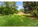 Expansive backyard with mature trees, lush greenery, and a well-maintained lawn at 2718 Ridgewood Ln, Rock Hill, SC 29730