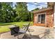 Charming patio with outdoor seating and grill, perfect for entertaining in a lush, green backyard at 2718 Ridgewood Ln, Rock Hill, SC 29730