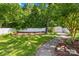 Spacious backyard with a lush lawn, mature trees, a storage shed, and a privacy fence for outdoor enjoyment at 3006 Emerald Meadow Ln, Charlotte, NC 28273