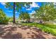 Lush backyard featuring a well-maintained lawn, mature trees, and a patio area, perfect for outdoor relaxation at 3006 Emerald Meadow Ln, Charlotte, NC 28273