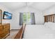 The primary bedroom features a vaulted ceiling, ceiling fan, and lots of natural light from the large window at 3006 Emerald Meadow Ln, Charlotte, NC 28273