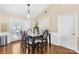 Well-lit dining room with hardwood floors, decorative lighting, and easy access to the outdoors at 3006 Emerald Meadow Ln, Charlotte, NC 28273
