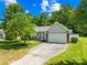 Charming single-story home with mature trees, well-manicured lawn, and two car garage at 3006 Emerald Meadow Ln, Charlotte, NC 28273