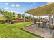 Well-maintained backyard with patio, lush lawn, and landscaped garden beds at 312 Farm Springs Dr, Mount Holly, NC 28120