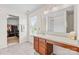 Bathroom showcasing a vanity, a large mirror, and a walk-in closet at 312 Farm Springs Dr, Mount Holly, NC 28120