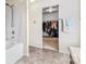Bathroom with a bathtub, shower, and an open view into a walk-in closet at 312 Farm Springs Dr, Mount Holly, NC 28120