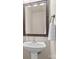 Bathroom with a pedestal sink, a decorative mirror, and a hand towel at 312 Farm Springs Dr, Mount Holly, NC 28120