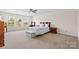 Spacious bedroom featuring carpet, a ceiling fan, and a view of the yard at 312 Farm Springs Dr, Mount Holly, NC 28120
