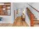 Bright foyer with hardwood floors, staircase, and white walls at 312 Farm Springs Dr, Mount Holly, NC 28120