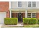 Inviting front entrance featuring manicured hedges and a classic dark-colored front door at 312 Farm Springs Dr, Mount Holly, NC 28120