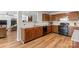 Kitchen featuring wooden cabinets, stone countertops, an eat-in counter and black appliances at 312 Farm Springs Dr, Mount Holly, NC 28120