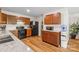 Kitchen with wooden cabinets and black appliances offering plenty of storage and cooking space at 312 Farm Springs Dr, Mount Holly, NC 28120