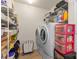Functional laundry room with modern washer, dryer, and storage shelves at 312 Farm Springs Dr, Mount Holly, NC 28120