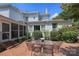 Backyard with brick patio, outdoor seating, mature landscaping, and a view of the home's architecture at 321 W Bank St, Salisbury, NC 28144