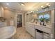 Elegant bathroom with a vanity, large mirror, and a view of an adjacent room, providing a seamless and open feel at 321 W Bank St, Salisbury, NC 28144