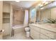 Bathroom featuring a shower/tub combo, tile flooring, and a white vanity with sink at 321 W Bank St, Salisbury, NC 28144