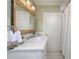 Bathroom featuring a modern vanity, elegant mirror, and shower with patterned wallpaper at 321 W Bank St, Salisbury, NC 28144