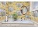 Charming powder room features patterned wallpaper, sink, and vanity at 321 W Bank St, Salisbury, NC 28144