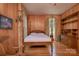 Charming bedroom with a four-poster bed, hardwood floors, and elegant window treatments at 321 W Bank St, Salisbury, NC 28144