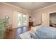 Cozy bedroom with hardwood floors, two windows, curtains, and neutral wall colors at 321 W Bank St, Salisbury, NC 28144