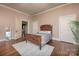 Bedroom featuring hardwood floors, multiple doors, neutral paint, and a bed with pillows at 321 W Bank St, Salisbury, NC 28144