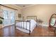 Bedroom featuring hardwood floors, a metal bed frame, french doors, and neutral paint at 321 W Bank St, Salisbury, NC 28144