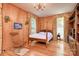 Charming bedroom with a four-poster bed, hardwood floors, and elegant window treatments at 321 W Bank St, Salisbury, NC 28144