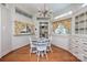 Bright breakfast nook with white chairs, hardwood floors and floral curtains at 321 W Bank St, Salisbury, NC 28144