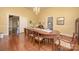 Elegant dining room with a large wooden table, chandelier, and beautiful hardwood floors at 321 W Bank St, Salisbury, NC 28144