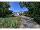 Estate-style home featuring a circular drive, expansive lawn, mature trees, and well-manicured landscaping at 321 W Bank St, Salisbury, NC 28144