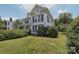 Charming two-story home featuring a well maintained lawn and manicured hedges at 321 W Bank St, Salisbury, NC 28144