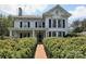 Charming two-story home featuring a brick pathway and manicured hedges at 321 W Bank St, Salisbury, NC 28144