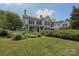 Charming two-story home featuring a well maintained lawn and manicured hedges at 321 W Bank St, Salisbury, NC 28144