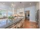 Open concept kitchen with stainless steel appliances, an island with bar seating, and hardwood floors at 321 W Bank St, Salisbury, NC 28144