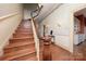 Elegant staircase featuring hardwood steps and charming wallpaper at 321 W Bank St, Salisbury, NC 28144