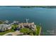Aerial view showcasing waterfront home with private dock, lush landscaping, and tranquil lake setting at 3386 Governors Island Dr, Denver, NC 28037