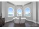 Luxurious bathroom with a freestanding tub, views of the lake through arched windows at 3386 Governors Island Dr, Denver, NC 28037