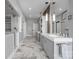 Bright bathroom featuring a double vanity, marble floors, and a glass-enclosed shower with decorative tile at 3386 Governors Island Dr, Denver, NC 28037