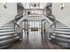 Grand foyer with a dual staircase, hardwood floors, and large windows with water views at 3386 Governors Island Dr, Denver, NC 28037
