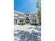 Front exterior view of a home with a prominent arched entryway and a paved driveway at 3386 Governors Island Dr, Denver, NC 28037