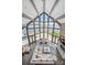 Bright living room with floor-to-ceiling windows offering waterfront views, stone fireplace and wood floors at 3386 Governors Island Dr, Denver, NC 28037