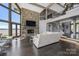 Open-concept living room with stone fireplace, hardwood floors, and lake views at 3386 Governors Island Dr, Denver, NC 28037